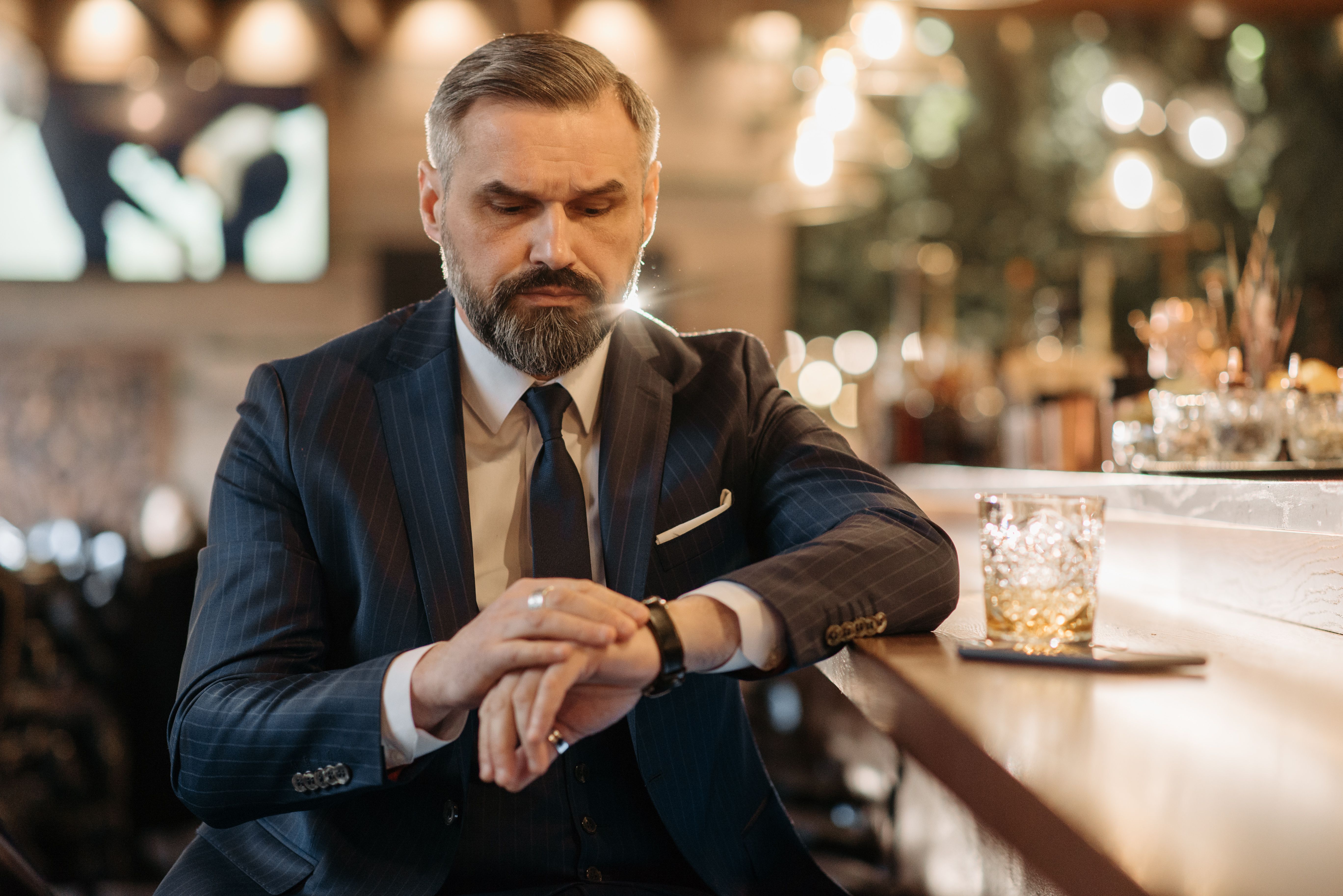 Image of man checking his watch